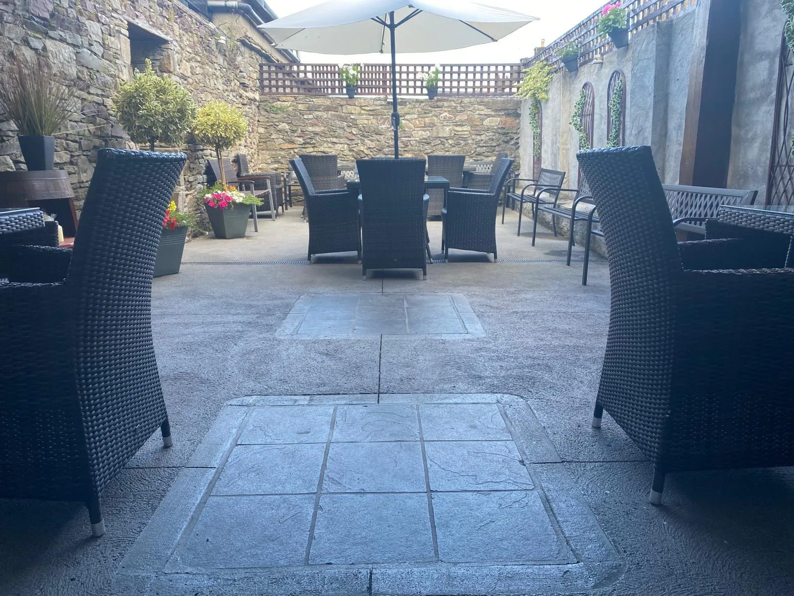 Outdoor tables in the stone-walled beer garden