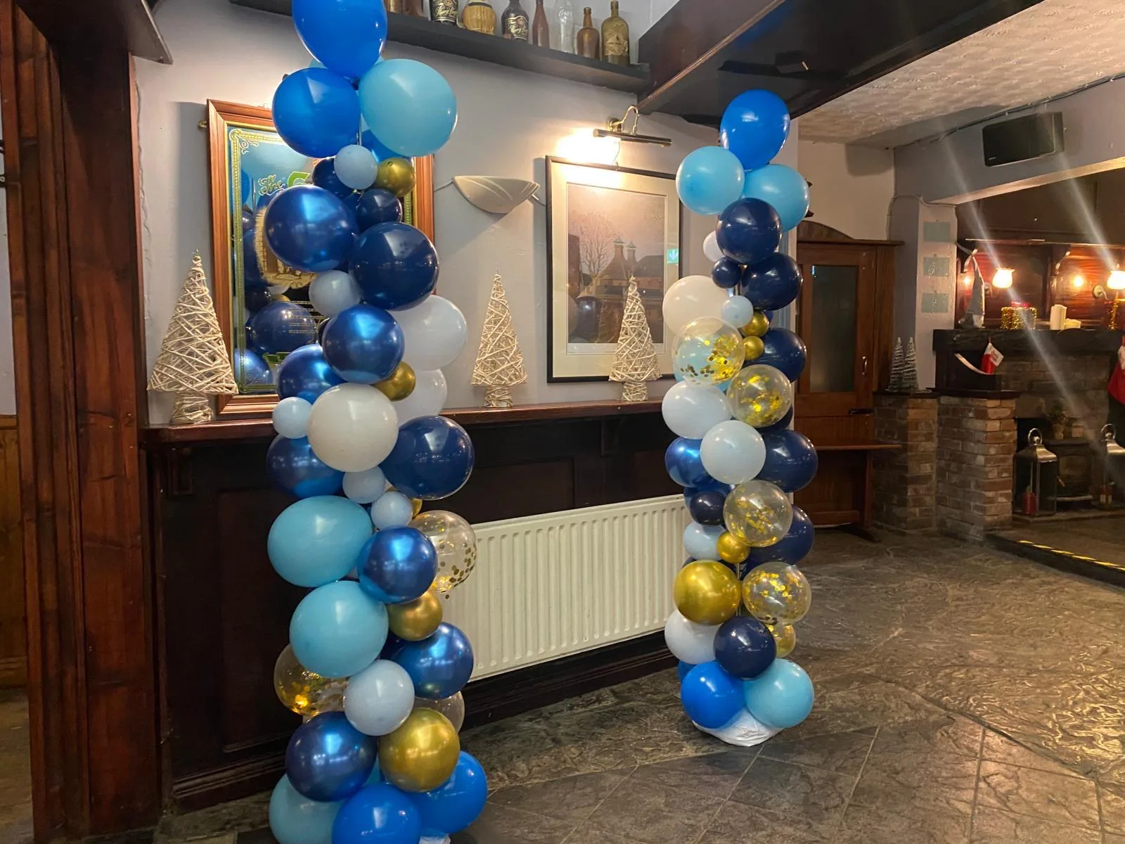 Blue and gold balloon decorations arranged for a celebration