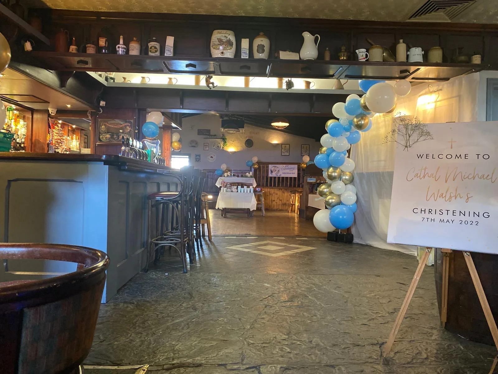 A christening function set-up with blue and gold balloons