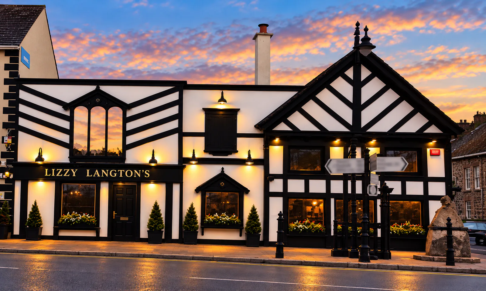 Lizzy Langton’s illuminated sign and front entrance on the Tallow pub exterior at dusk