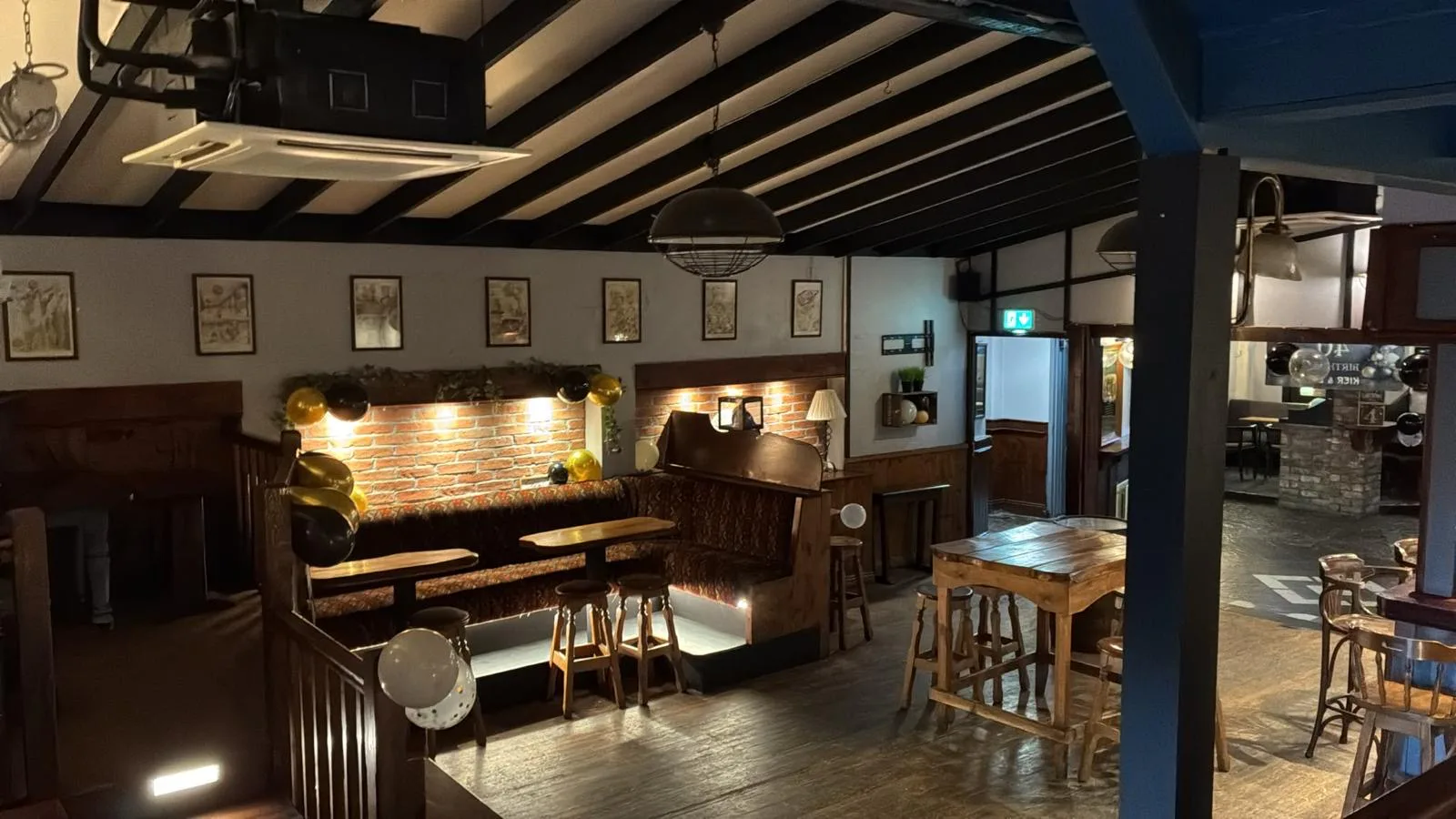Cosy booth seating with brick detail and timber tables